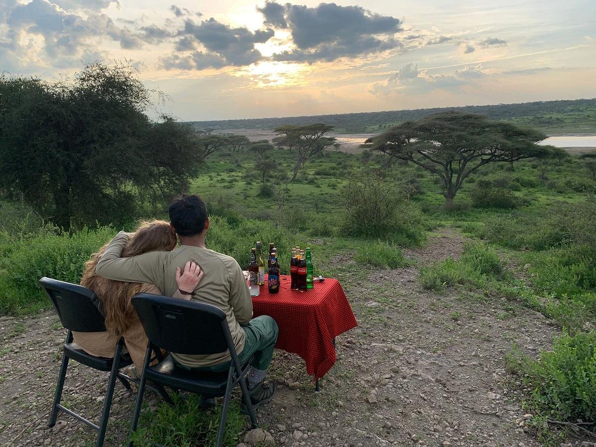 Sundowners set out above a lake at sunset